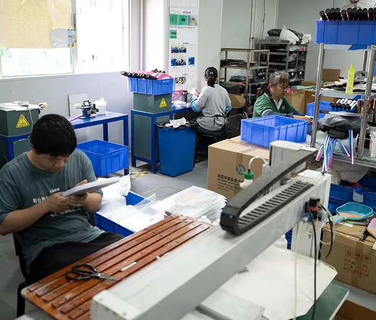 Staff inspecting paddles at workbenches